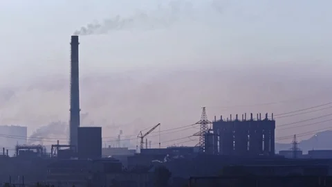 Billowing steam from smoke stack filling sky. Smoking chimneys of a steel pow Stock Footage 112775218