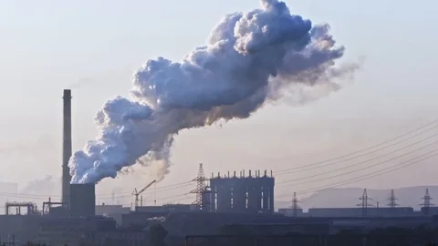 Billowing steam from smoke stack filling sky. Smoking chimneys of a steel pow 動画素材 112775250