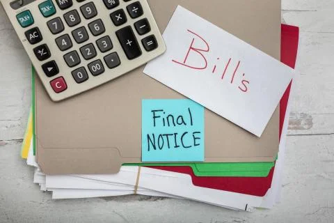 Bills final notice note cards sitting on stacks of paper statements payments Stock Photos