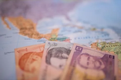 Bills of one, five, and two lempiras under Honduras on a blurry America map Stock Photos