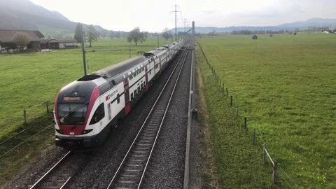 BILTEN - APRIL 20, 2021 Static shot, SBB Train driving through rural part of Stock Footage 153199549