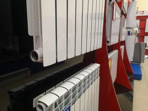 A bimetallic heating radiator of eight sections is sold in the window of a .. Stock Photos