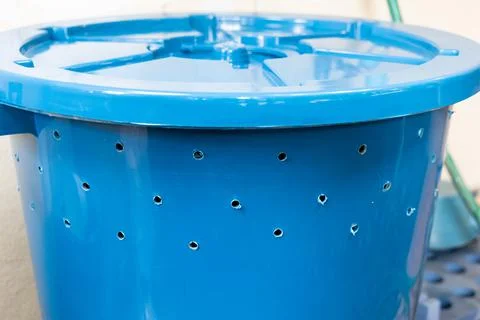 Bin with multiple holes drilled to be used to produce organic compost fertilizer Stock Photos