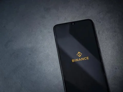 Binance app launch screen on smartphone on dark marble stone background Stock Photos