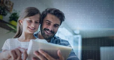 Binar code pattern over father and daughter smiling using tablet 스톡 사진
