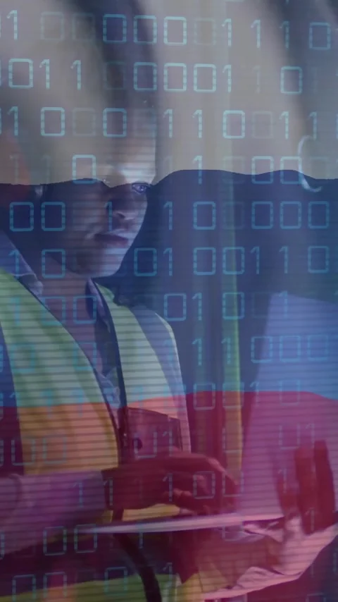Binary code and flag animation over worker using laptop in industrial setting Video stock 323780916