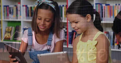 Binary code animation over children using tablets in school library Stock Footage 305063405