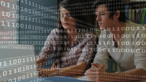 Binary code animation over two people working together on laptop Stock Footage 305432714