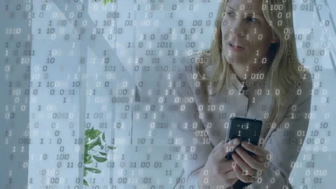 Binary code animation over woman holding smartphone and looking away Stock Footage 303794002