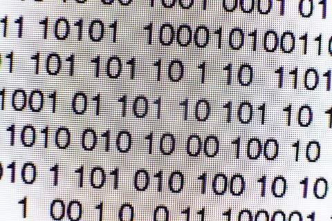 Binary code on a computer screen Stock Photos