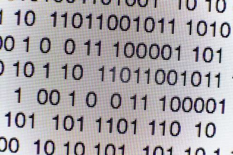 Binary code on a computer screen Stock Photos