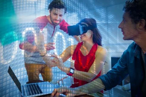 Binary code on digital screen against colleagues using technology Stock-Fotos