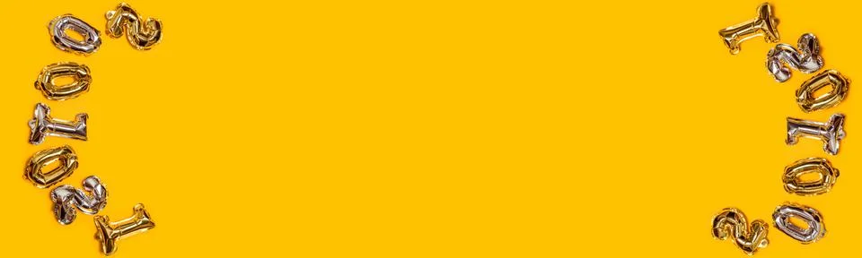 Binary code. Gold and silver 0 and 1 number foil ballons on a yellow backgrou 스톡 사진