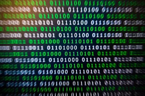 Binary code green blue digital color on black background with zoom effect for Stock Photos