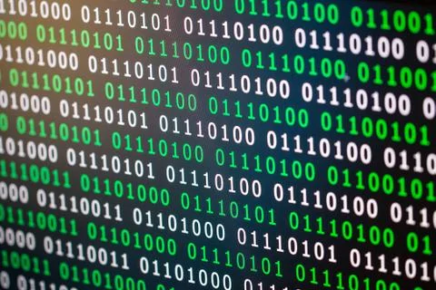 Binary code green blue digital color on black background with zoom effect for Stock Photos