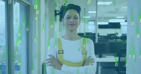 Binary code image over confident businesswoman standing in modern office 스톡 사진