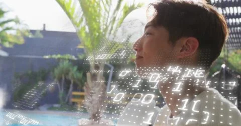 Binary code image over person relaxing by pool with palm trees 写真素材