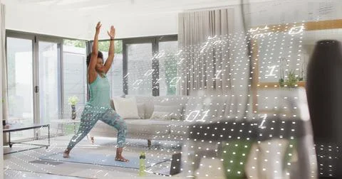 Binary code image over woman practicing yoga in living room Stock Photos