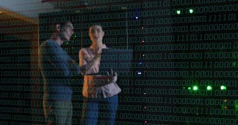 Binary code over people discussing in data center Stock Photos