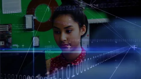 Binary code overlay scrolling and shifting revealing student typing and Stock Footage 314175023