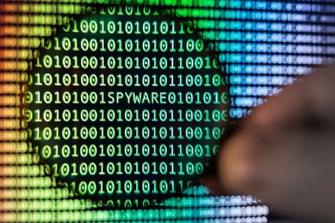 Binary Code screen Binary code, Magnifying glass shows spyware, toned Copy... Stock Photos
