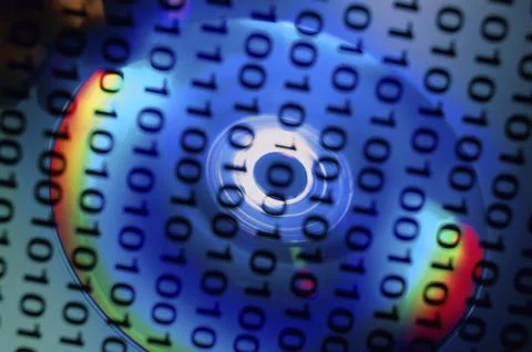 Binary code superimposed over a compact disc 스톡 사진