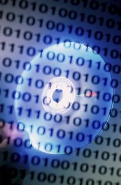 Binary code superimposed over a compact disc Foto stock