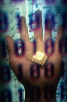 Binary code superimposed over a persons hand holding a computer chip 스톡 사진
