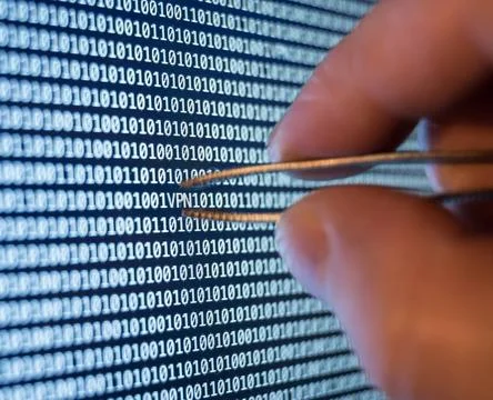 Binary code Vpn spotted, taking out with tweezers binary code Copyright: x... Stock Photos