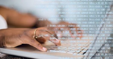 Binary coding data processing against mid section of person using laptop 스톡 사진