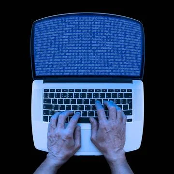 Binary Coding on the Laptop A developer in informatics is using a laptop t... 库存照片