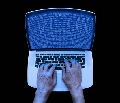 Binary Coding on the Laptop A developer in informatics is using a laptop t... Stockfoto's