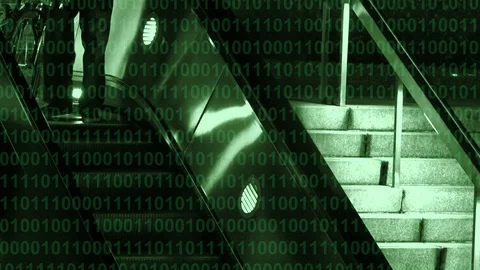 Binary computer code scrolling over a subway escalator 库存影片 101860617