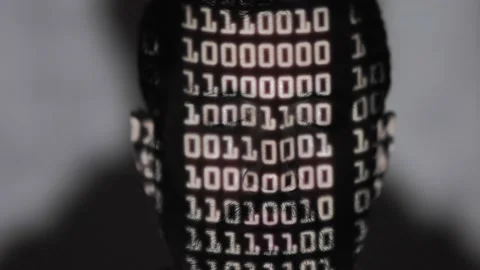 Binary language projected onto a hacker's face Stock-Footage 167683339