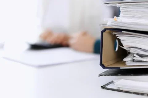 Binders with papers are waiting to be processed by business woman or bookkeeper Foto stock