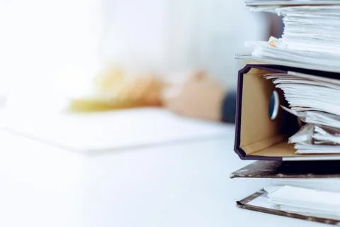 Binders with papers are waiting to be processed by business woman or bookkeeper Foto stock