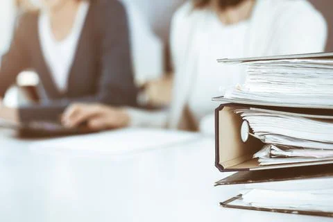 Binders with papers are waiting to be processed by business woman or bookkeeper Foto stock