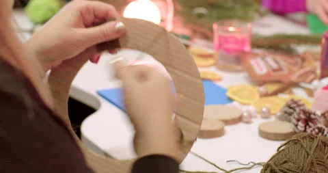 Binding cardboard base thread woman hand pushes ball through hole. Stock Footage 239466975