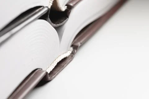 Binding of a new book. Close-up of a layer of pages. Library background Stock Photos