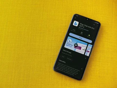 Bing Browser app play store page on smartphone on a yellow fabric background Stock Photos
