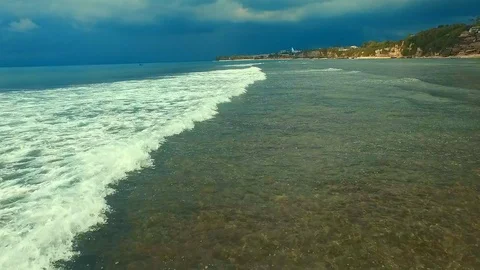 Bingin beach Bali Indonesea soft wave low tide relax rock coral riff point Stock Footage 106570531