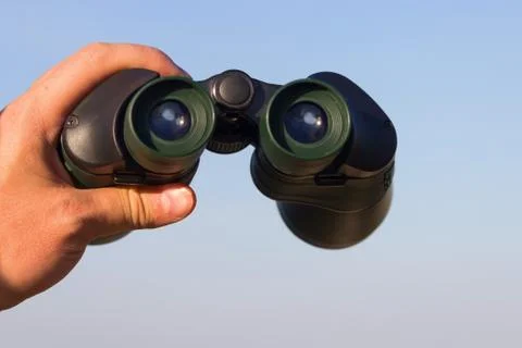 Binocular in mans hands Stock Photos