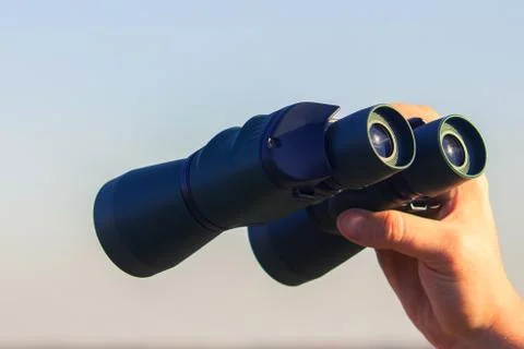 Binocular in mans hands Stock Photos