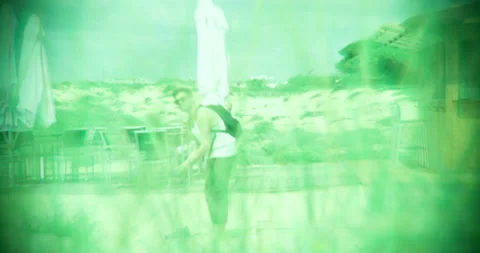 Binocular view: Man taking off his shoes on the beach Stock Footage 205022666