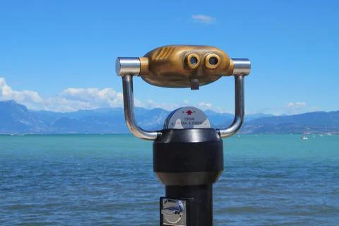 Binocular viewer against lake and mountain background. Stock Photos