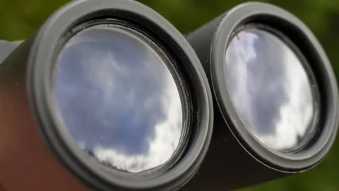 Binoculars Front Lens Reflecting Light and Clouds Close Up Stock Footage 127692474