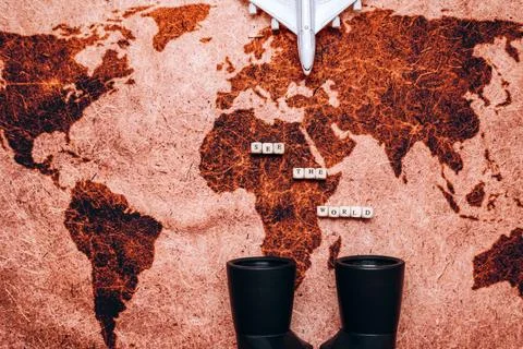 Binoculars, map and model of an airplane on the table. Top view of traveler.. Stock Photos