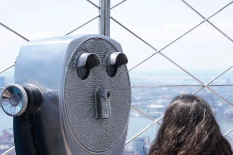 Binoculars sit on a high observation deck to give tourists a birds eye view Stock Photos