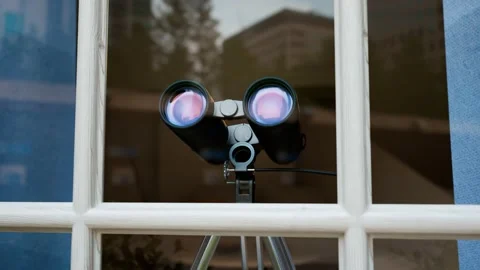 Binoculars in a window. Spying technology. Spy gear. Observation equipment. Vidéo 145768669