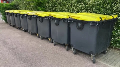 Bins with plastic waste lined up awaiting collection for recycling Stock Footage 311915338